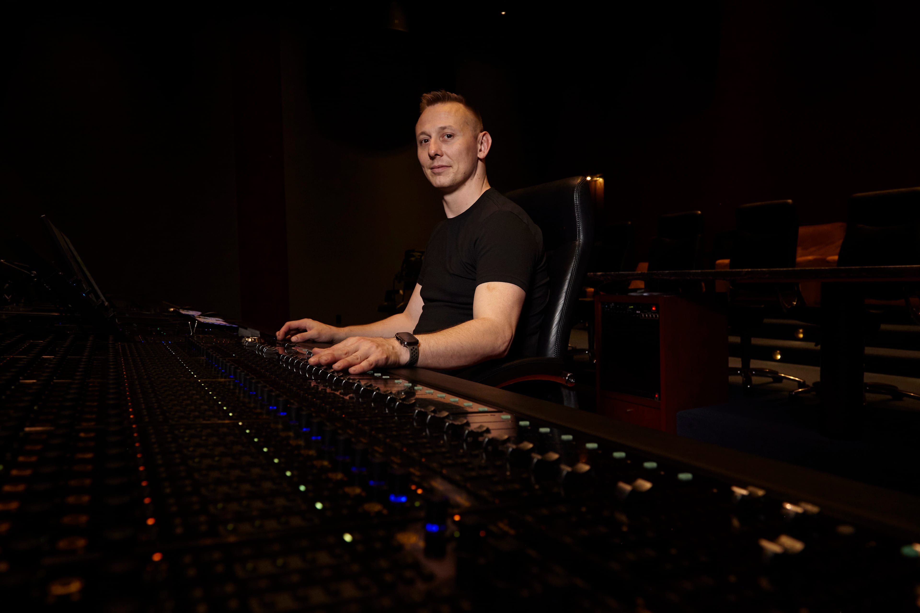 Jason Abell at the mixing console on a dubbing stage.